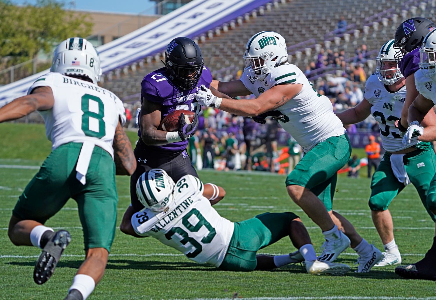 Sep 25, 2021; Evanston, Illinois, USA; Northwestern Wildcats running back Anthony Tyus III (27) runs the ball as Ohio Bobcats safety Michael Ballentine (39) tackles him during the first half at Ryan Field. Mandatory Credit: David Banks-USA TODAY Sports